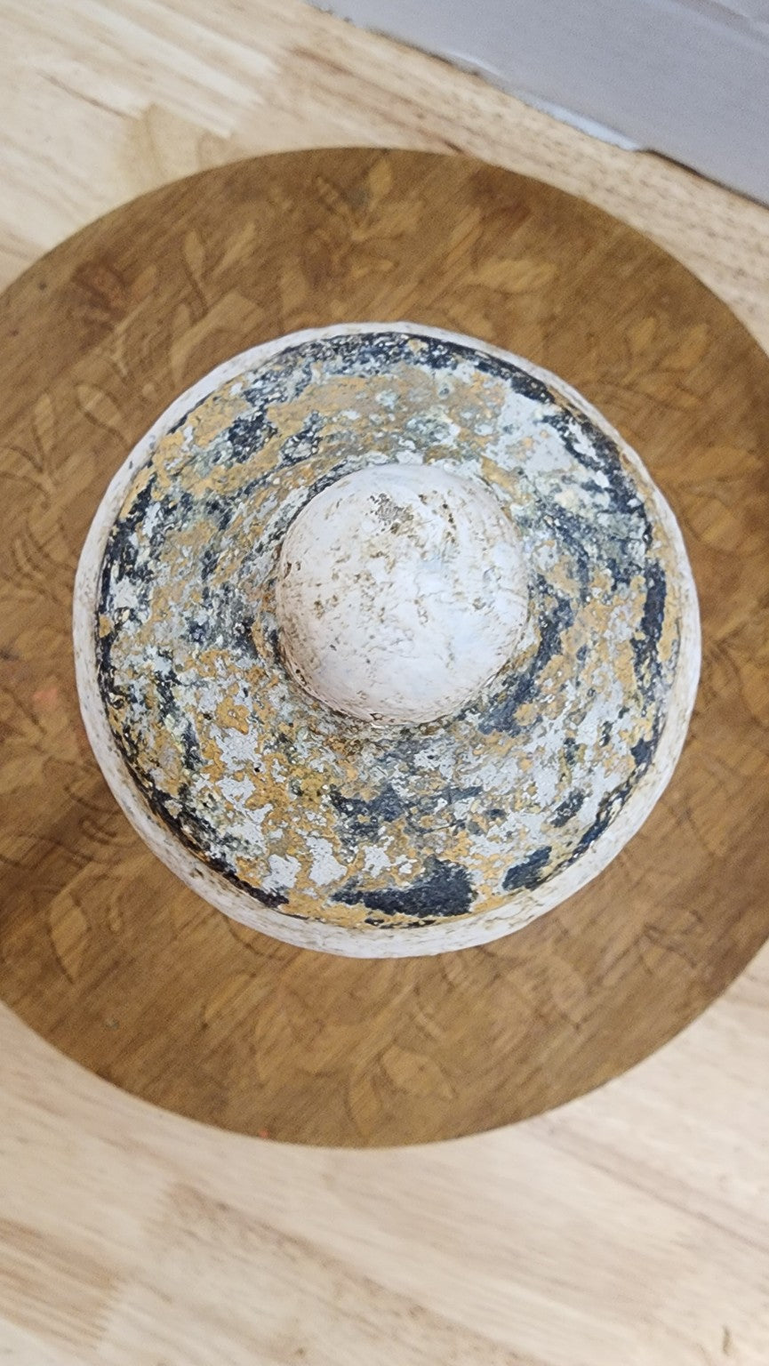 Top view of wood finial showing cracked layered patina