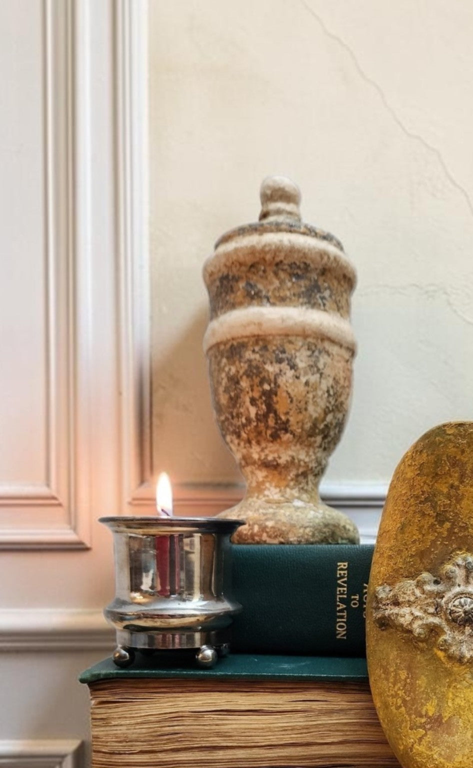 Wood finial styled on books with candle