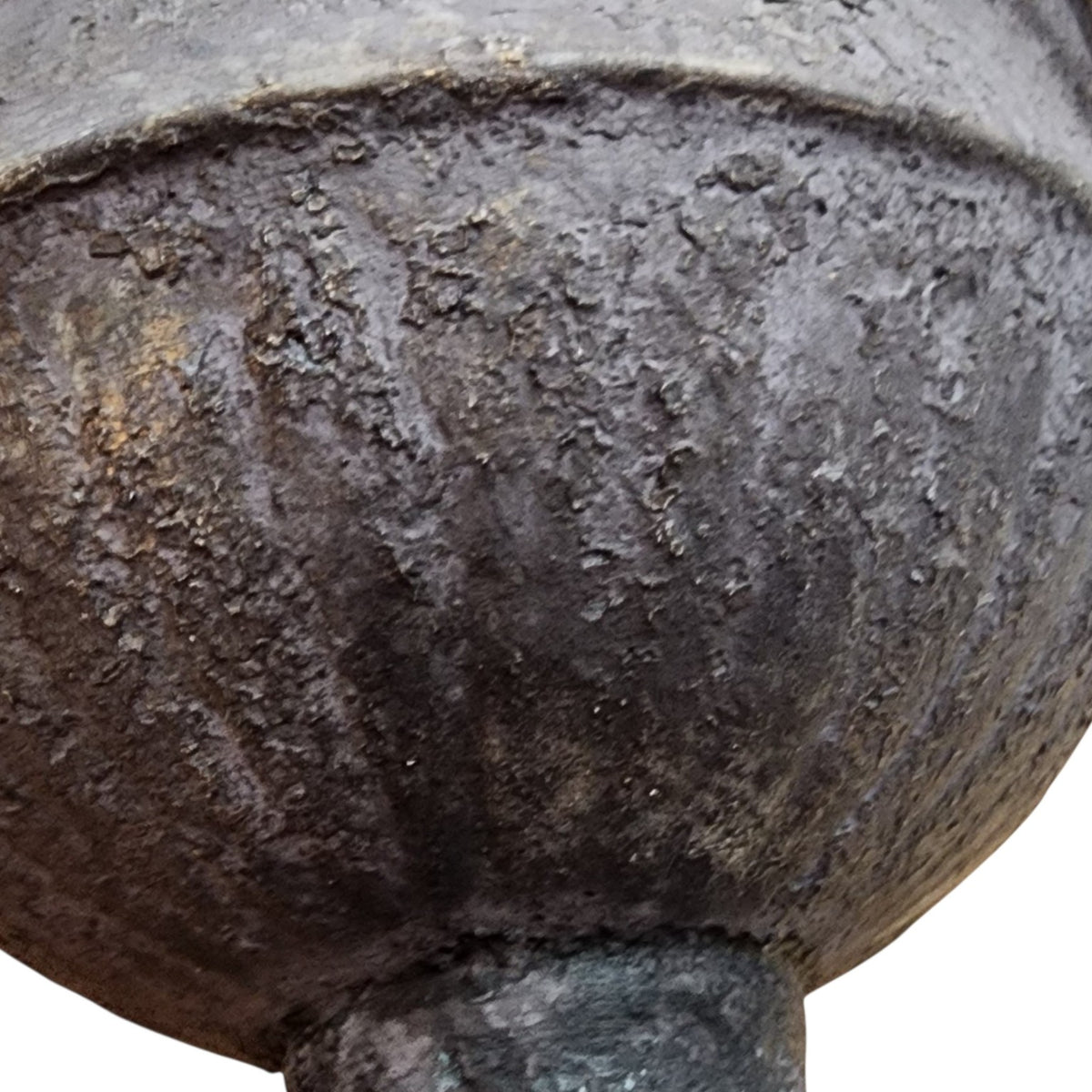 Underside and aged marks of metal urn
