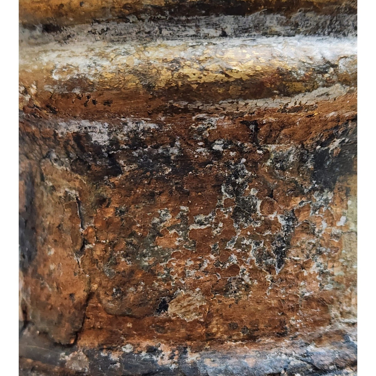 Detail of aged gold umber and moss green artisan finish