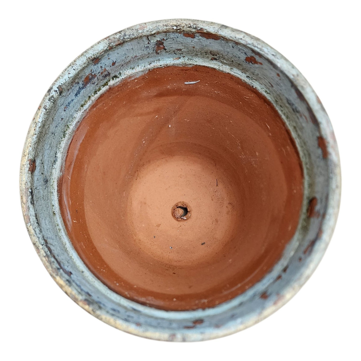 Interior view of hand-painted terracotta pot with drainage hole