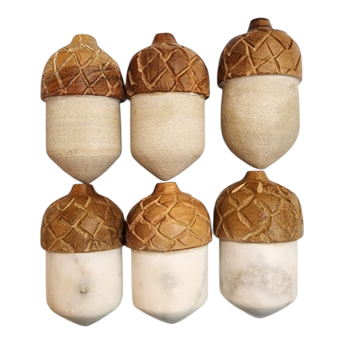 Marble acorns showing polished and softer matte surface appearances