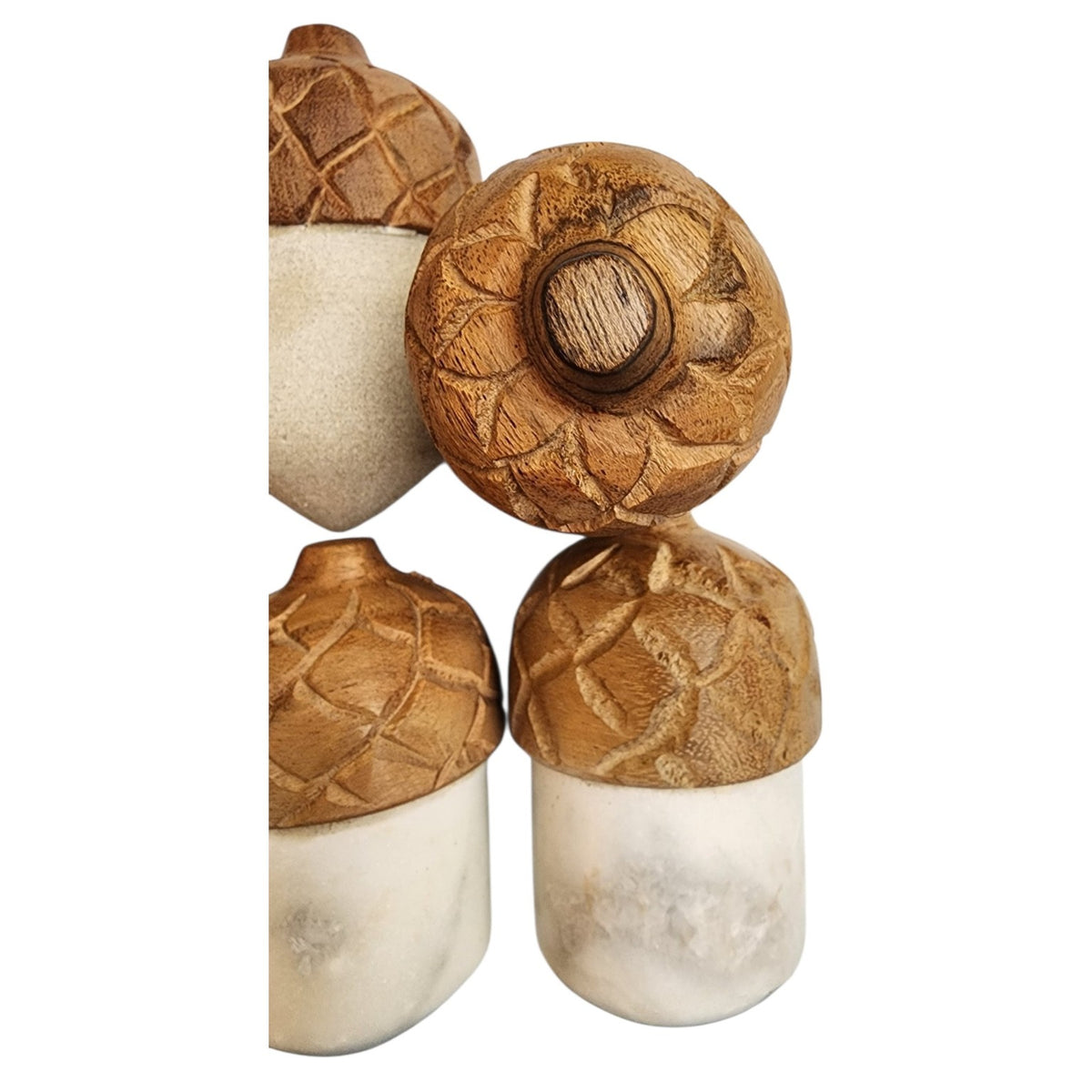 Close-up of six marble acorns with carved wood caps