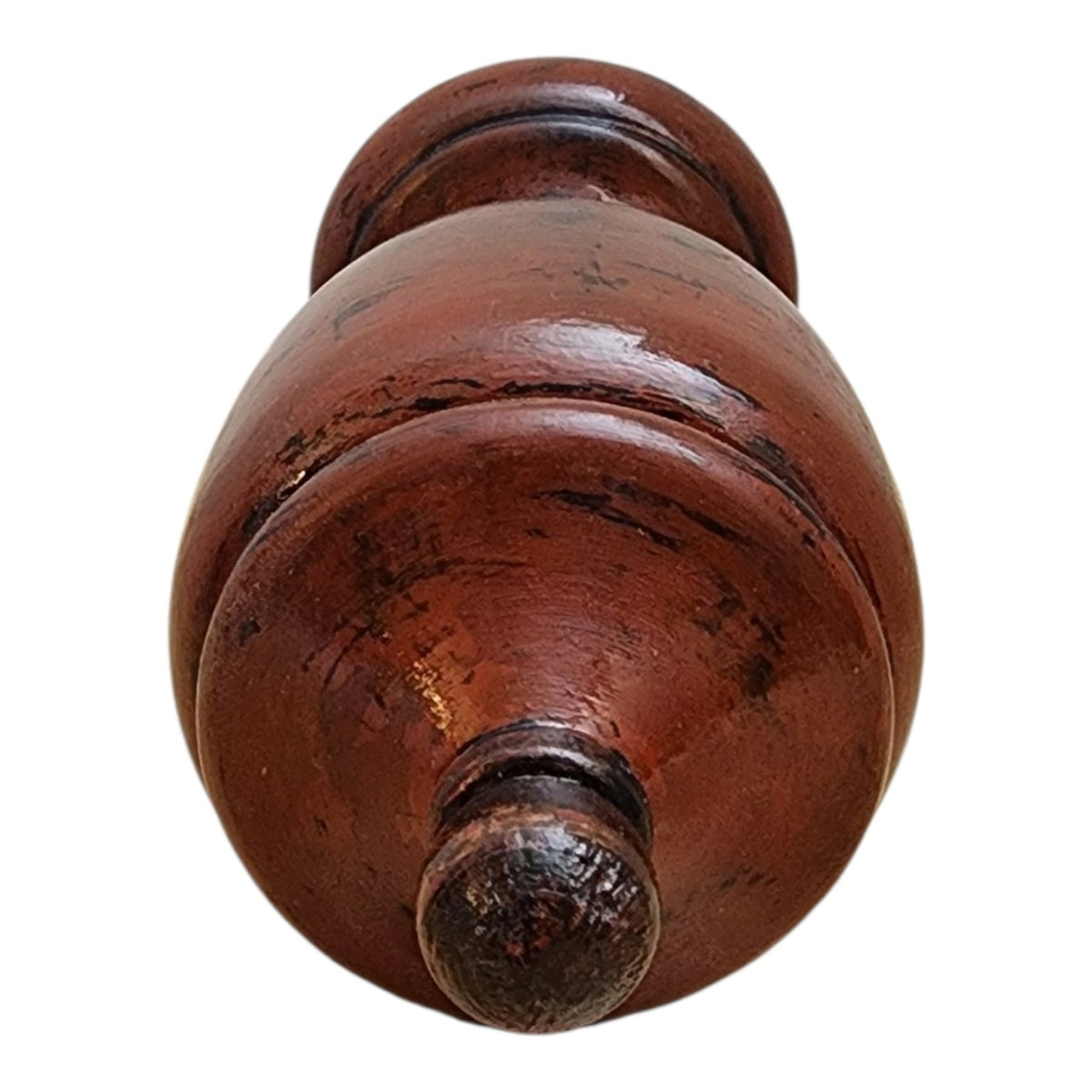 Close detail showing distressed red and black specialty finish on solid wood vessel