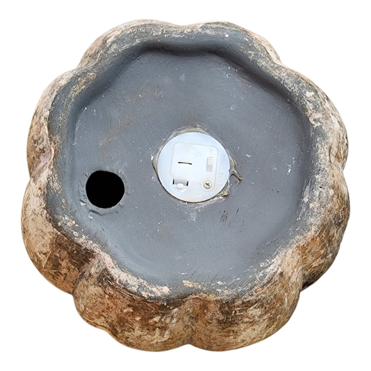 Battery compartment on bottom of ceramic jack-o'-lantern