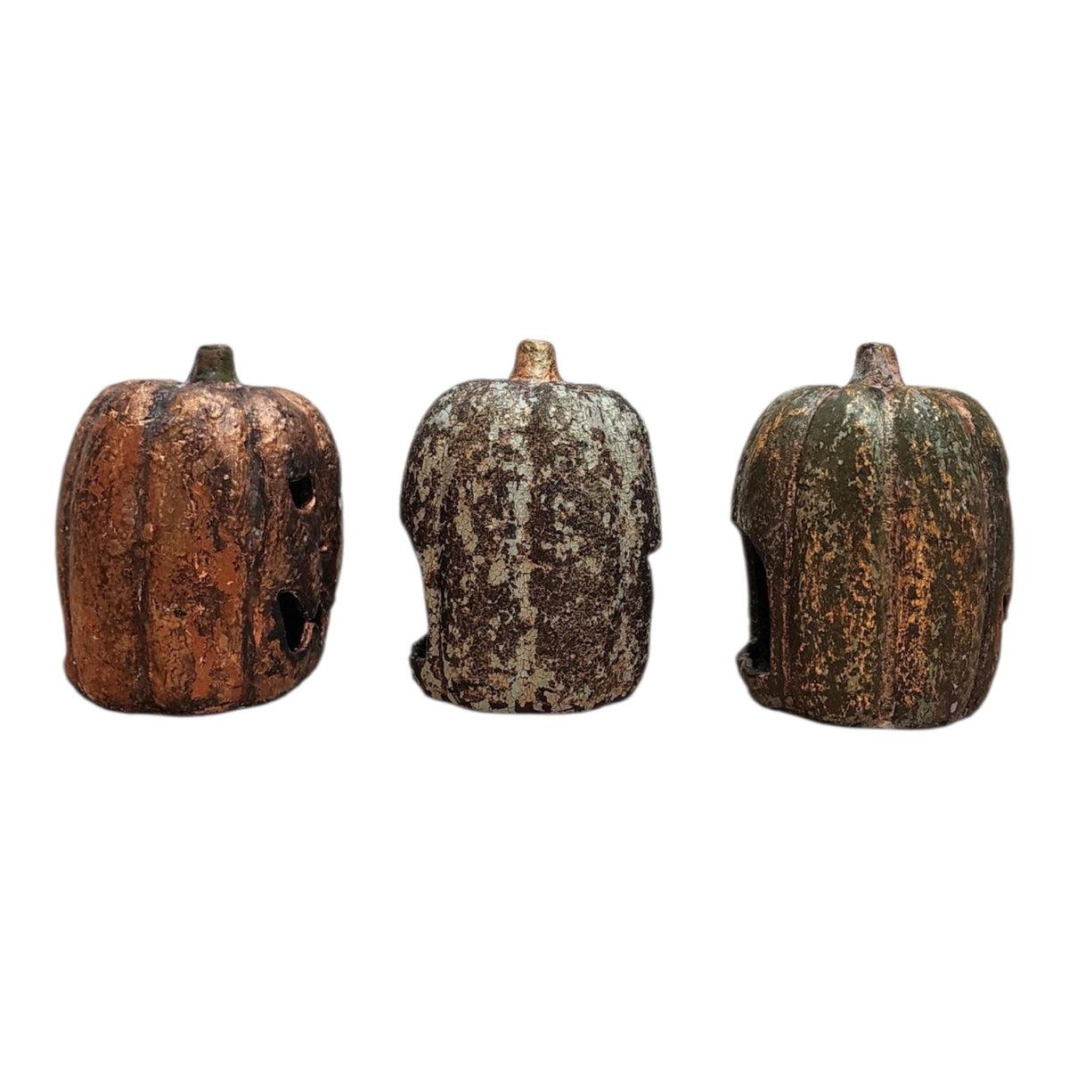 Rear candle openings of three ceramic jack-o-lantern pumpkins