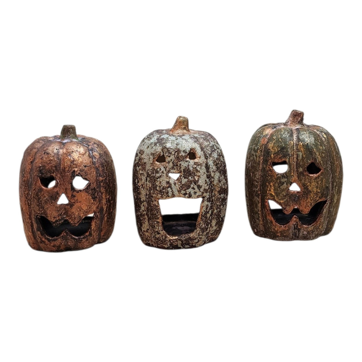 Front view of three one-of-a-kind hand-finished ceramic jack-o-lantern pumpkins