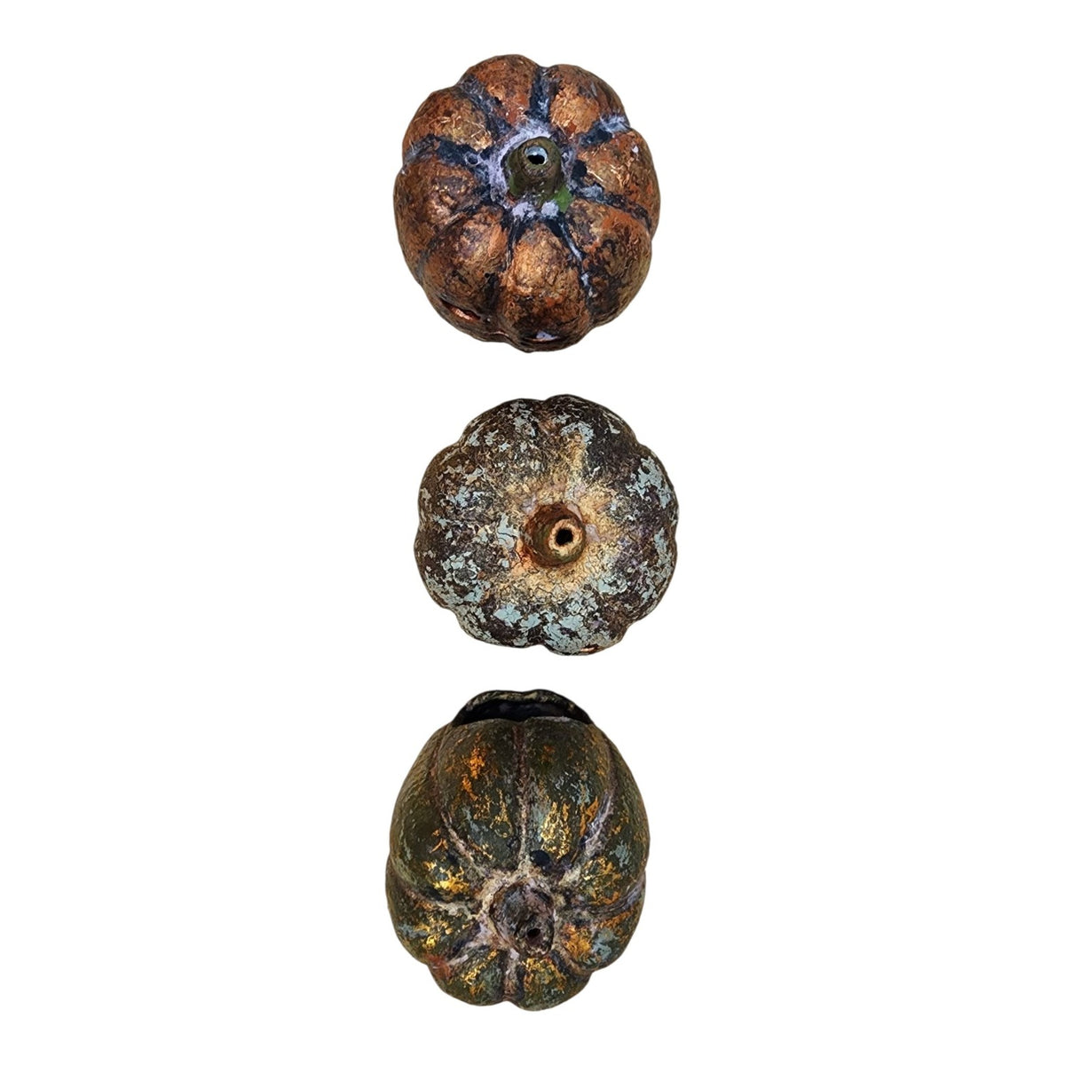 Top view of three ceramic pumpkins showing individual hand-applied OWR finishes